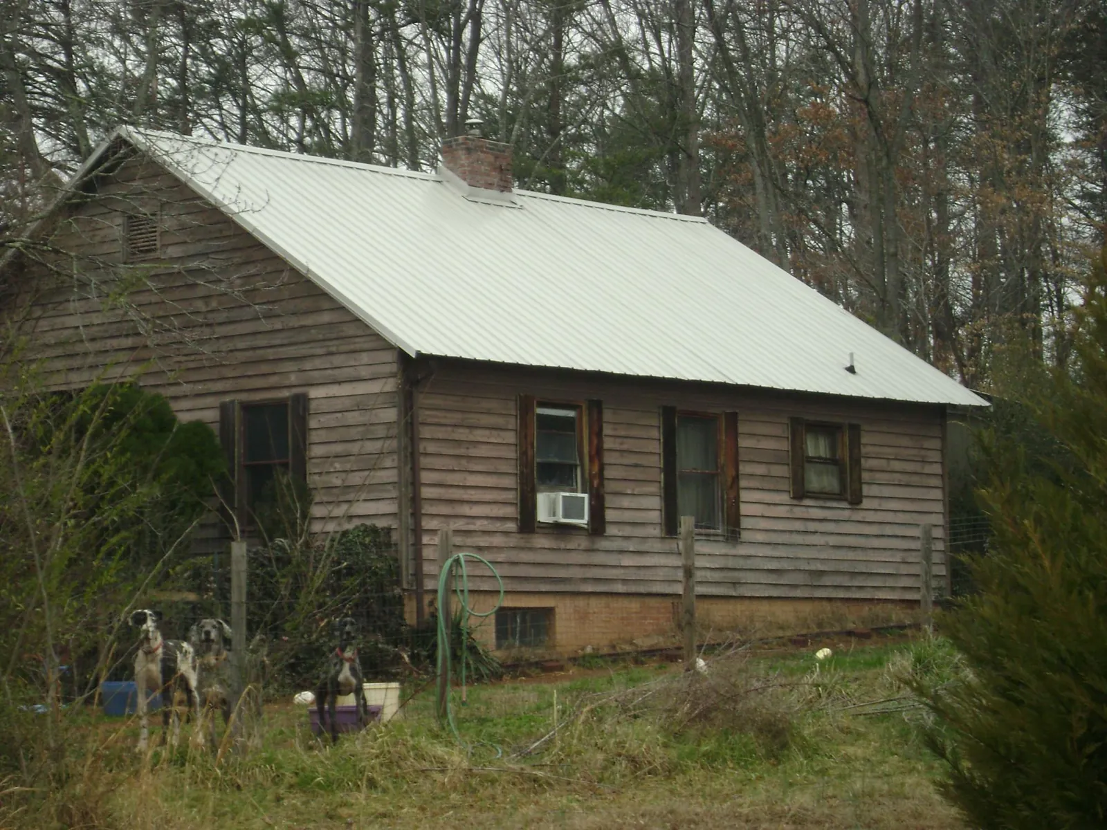 White metal roof on an old wood sided farmhouse, from a Metal Roof Installation job in Westfall